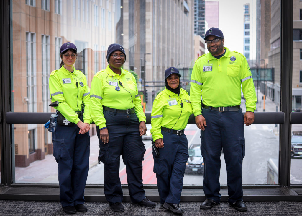 Four Safety Ambassadors in Downtown Minneapolis posing for a photo