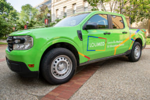 A Green LouMed branded Block by Block Ambassador truck.