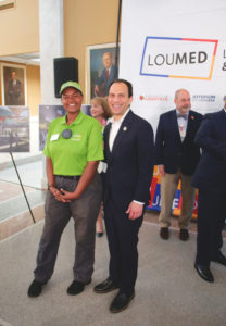 Mayor Craig Greenberg stands beside a Louisville Medical LOUMED Block by Block Ambassador.