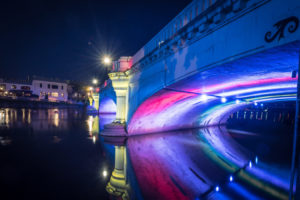 Photo of a bridge lit up from below