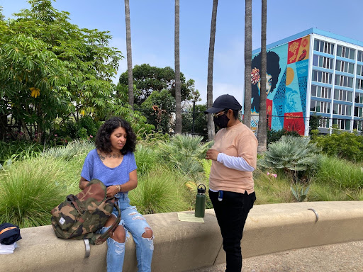 An Outreach Worker speaks to a woman sitting down.