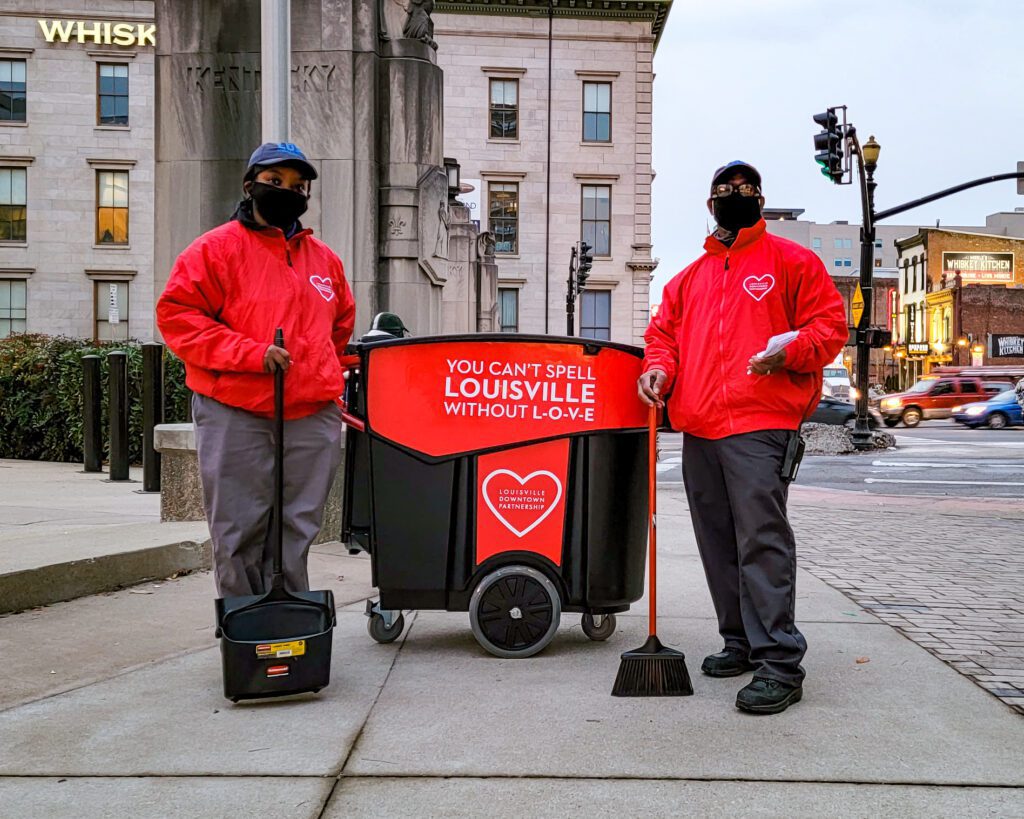 Two Louisville Ambassadors stand next to a Mega Brute for Valentines Day.